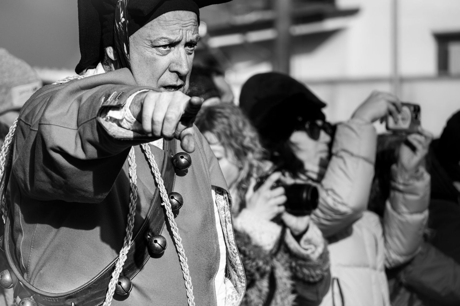 Traditional Mamuthones and Issohadores masks around the fire in Mamoiada, Sardinia - Black and white reportage by Marco Eretta