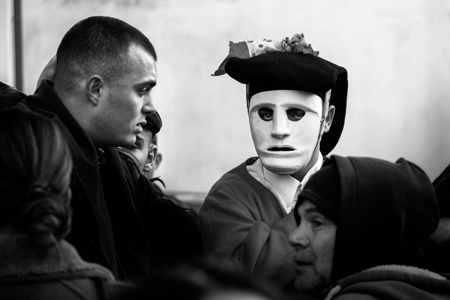 Traditional Mamuthones and Issohadores masks around the fire in Mamoiada, Sardinia - Black and white reportage by Marco Eretta