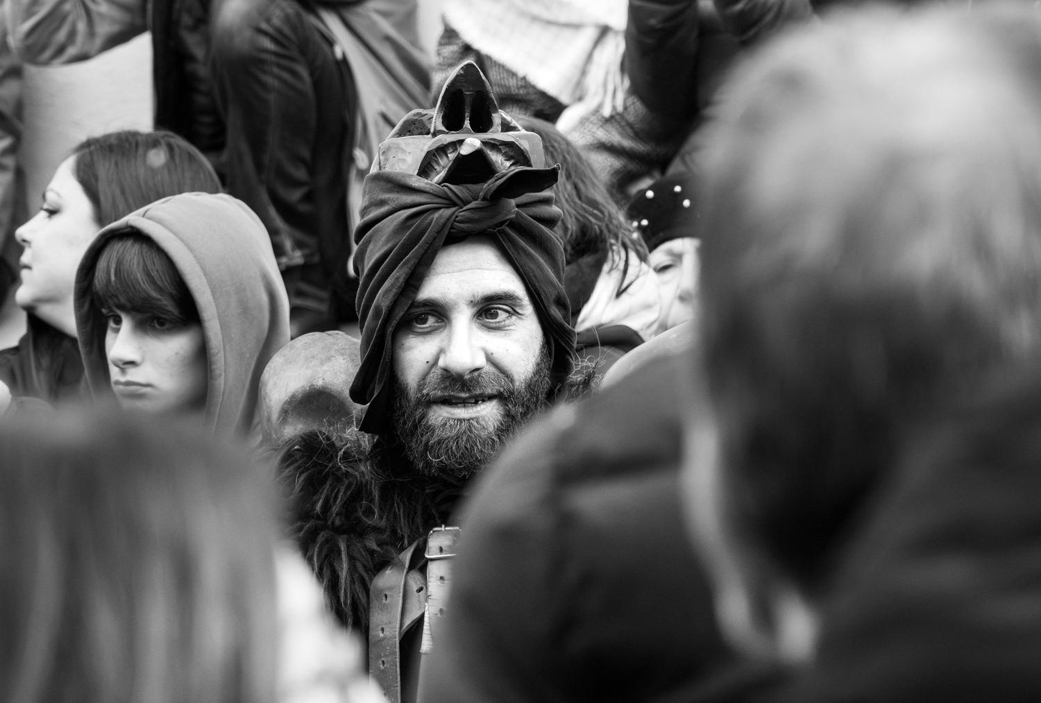 Traditional Mamuthones and Issohadores masks around the fire in Mamoiada, Sardinia - Black and white reportage by Marco Eretta
