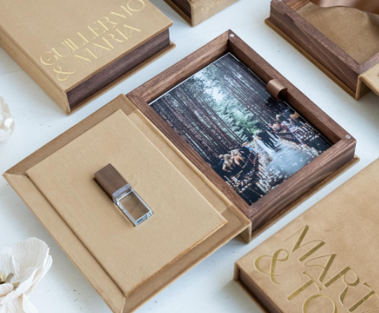 Personalized wooden wedding photo box with USB drive and printed photos, custom engraved with names Guillermo and Maria.