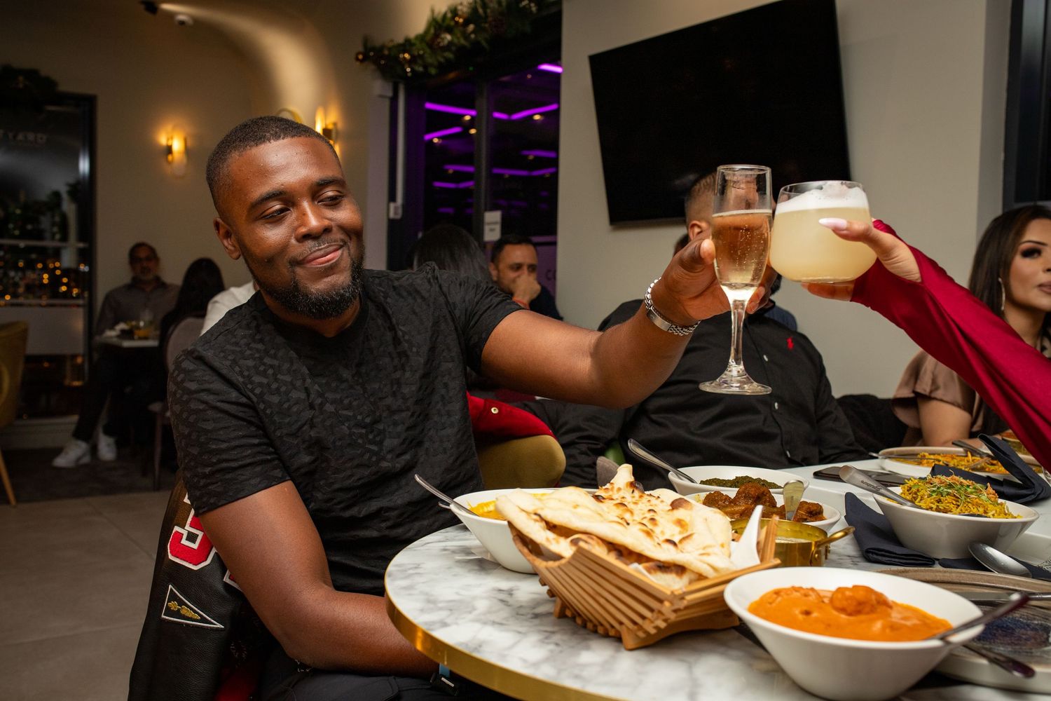 Guests enjoying food and drinks during restaurant grand opening event in Heathrow, London, UK