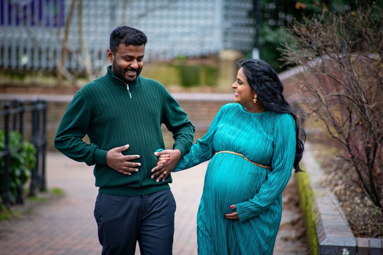 Expecting couple walking together during relaxed maternity photoshoot in London, UK