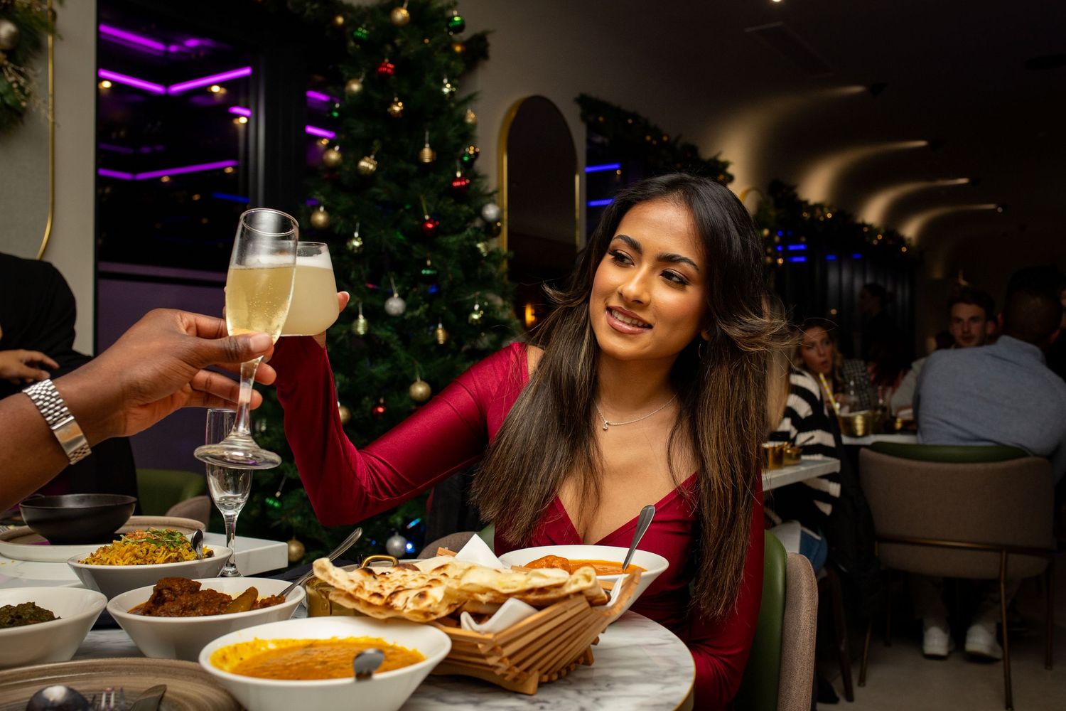 Guests celebrating restaurant grand opening with drinks and dining atmosphere in Heathrow, London, UK