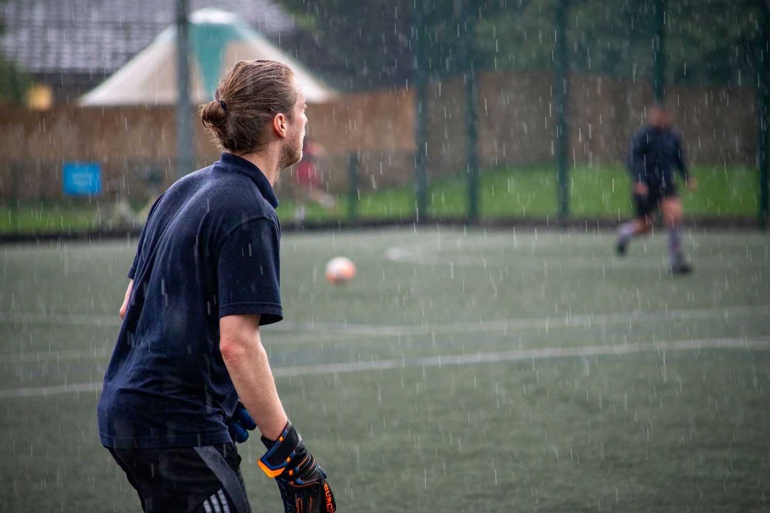 Goalkeeper watching play during football match with candid sports photography in London, UK