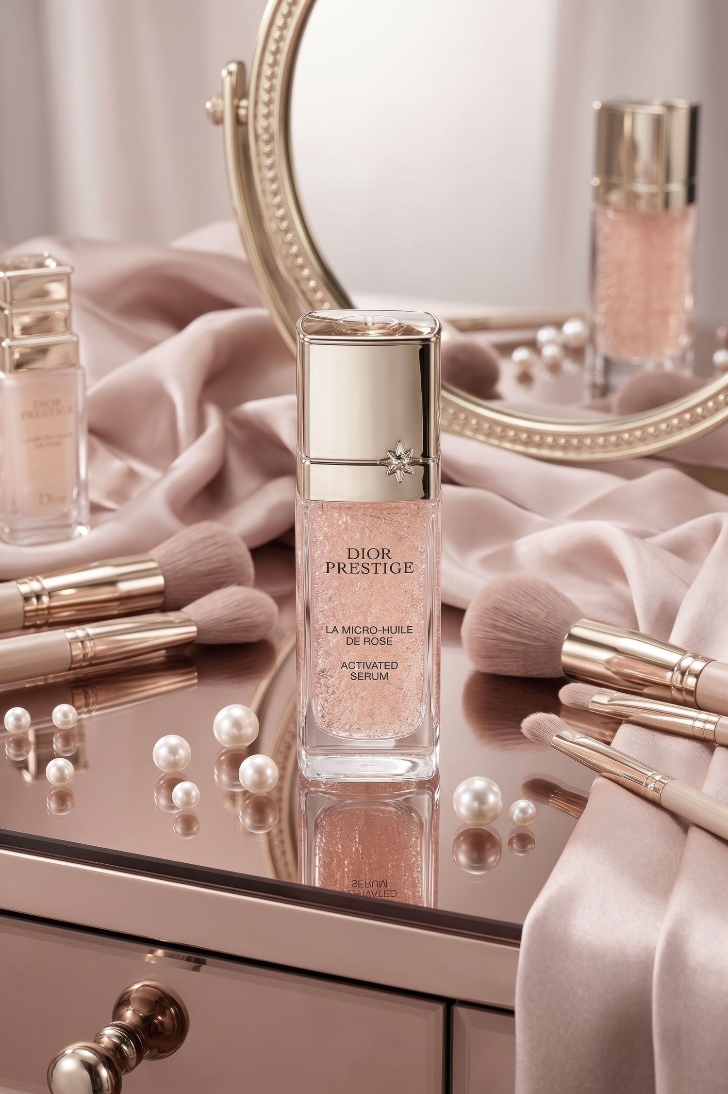 Dior Prestige La Micro-Huile de Rose serum bottle surrounded by brushes and pearls on pink silk vanity.