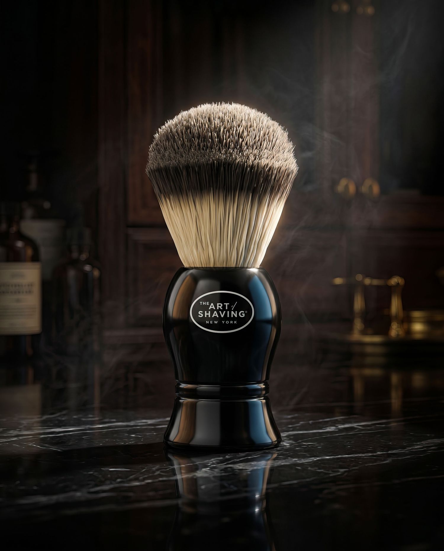 The Art of Shaving black handle badger hair shaving brush on dark marble surface.