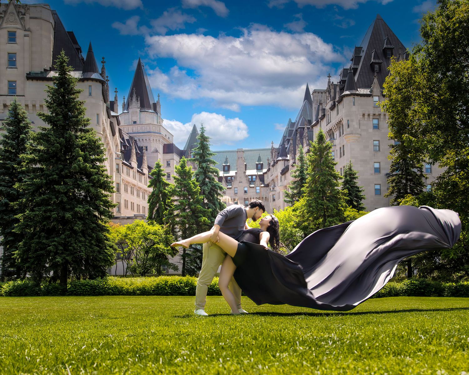 Couple dancing romantically with black flowing fabric before Chateau Laurier in Ottawa. Ottawa flying dress photography.