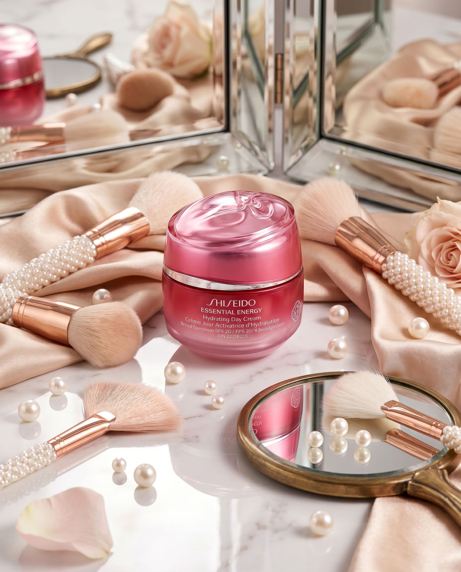 Shiseido Essential Energy face cream surrounded by pearl-handled brushes and pink roses.
