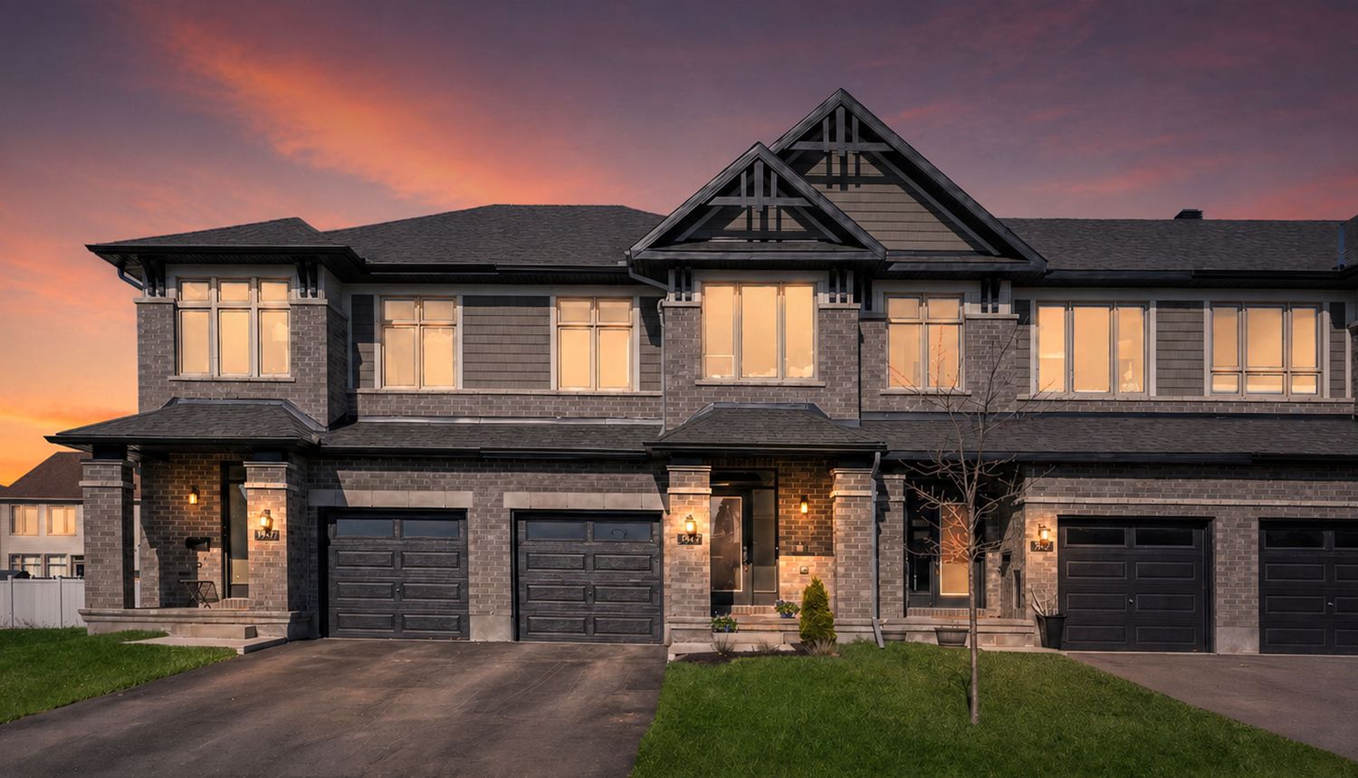 Ottawa real estate photography showcasin a stunning craftsman-style townhome exterior at sunset with stone facade and double garage.