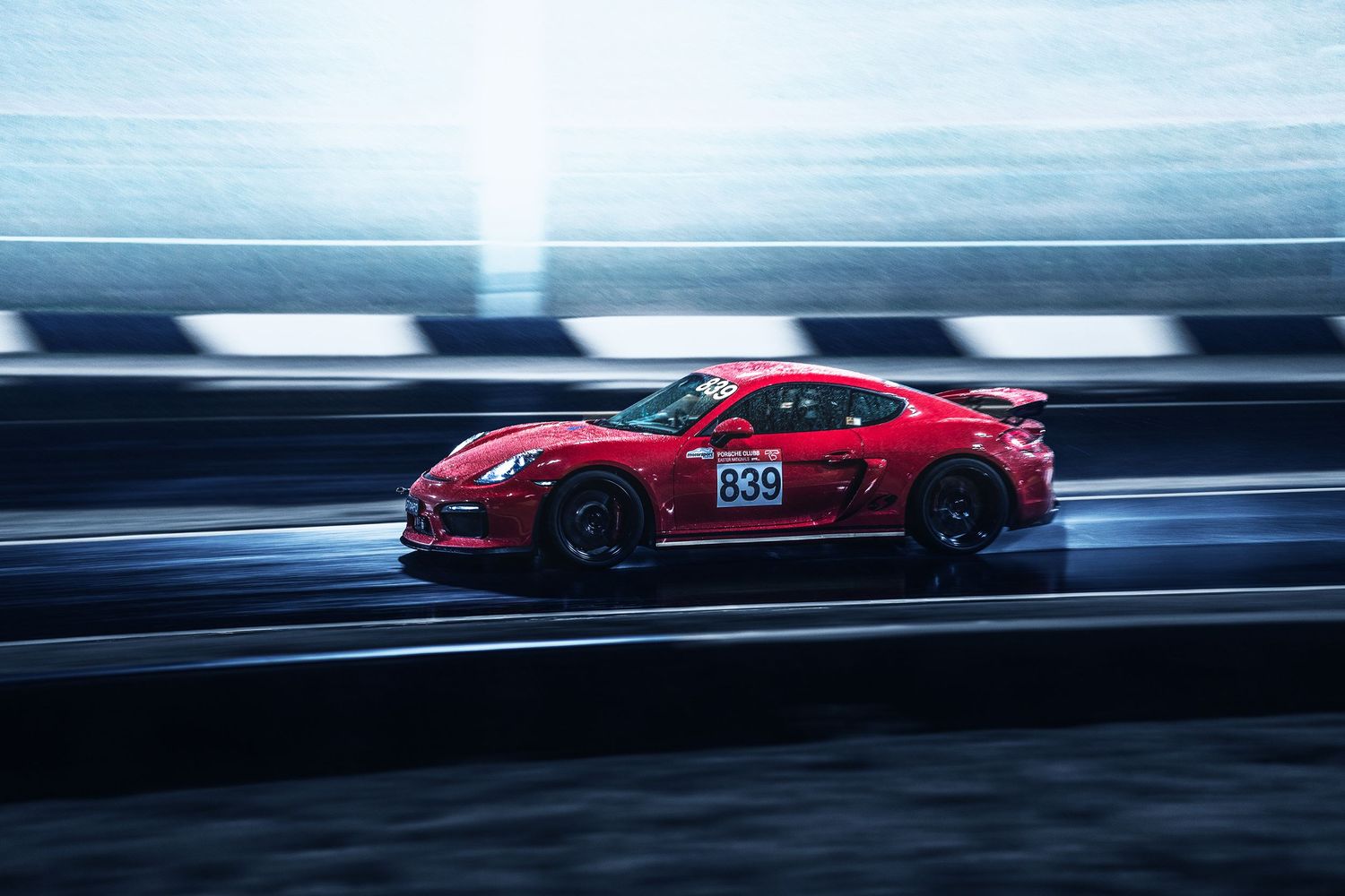 A red track Porsche doing laps at Sydney Motorsport park in Eastern creek.