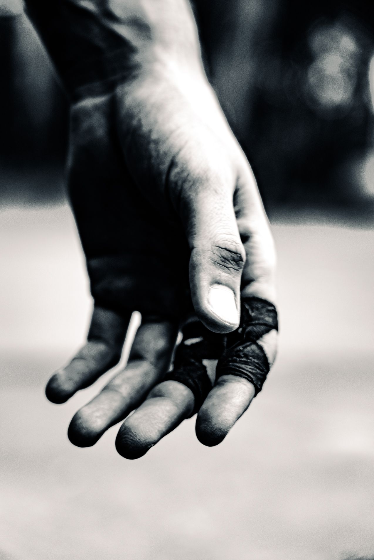 A fighters hand, wrapped with tape.