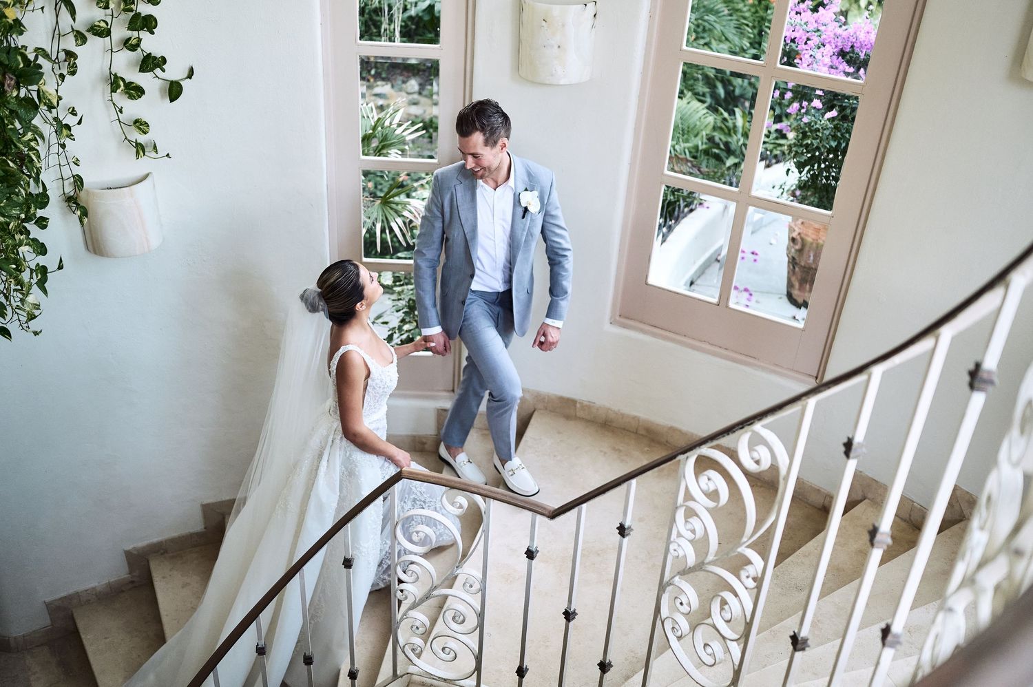 An elegant staircase with white railings in a bright indoor venue.