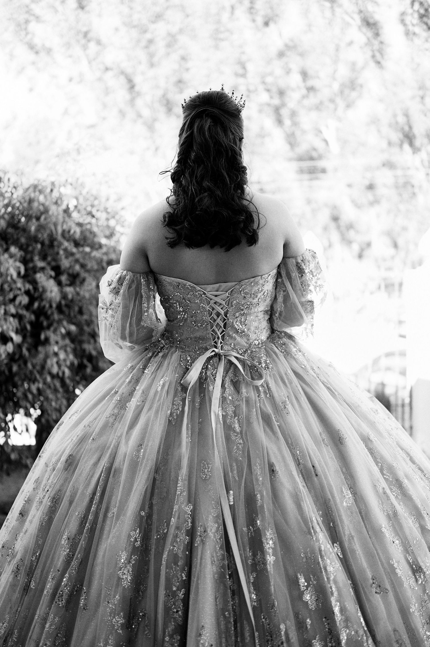 Close-up details of an ornate white ball gown with lace and embellishments.
