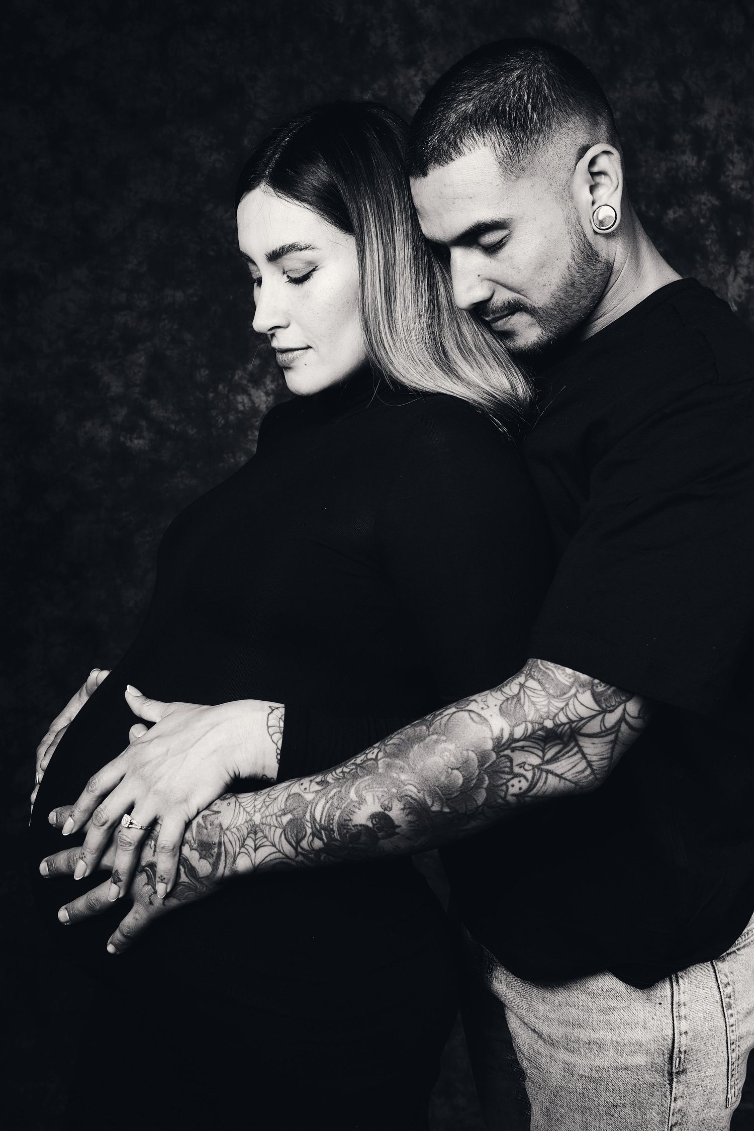 Series of intimate black and white photos showing couple embracing with visible tattoos.