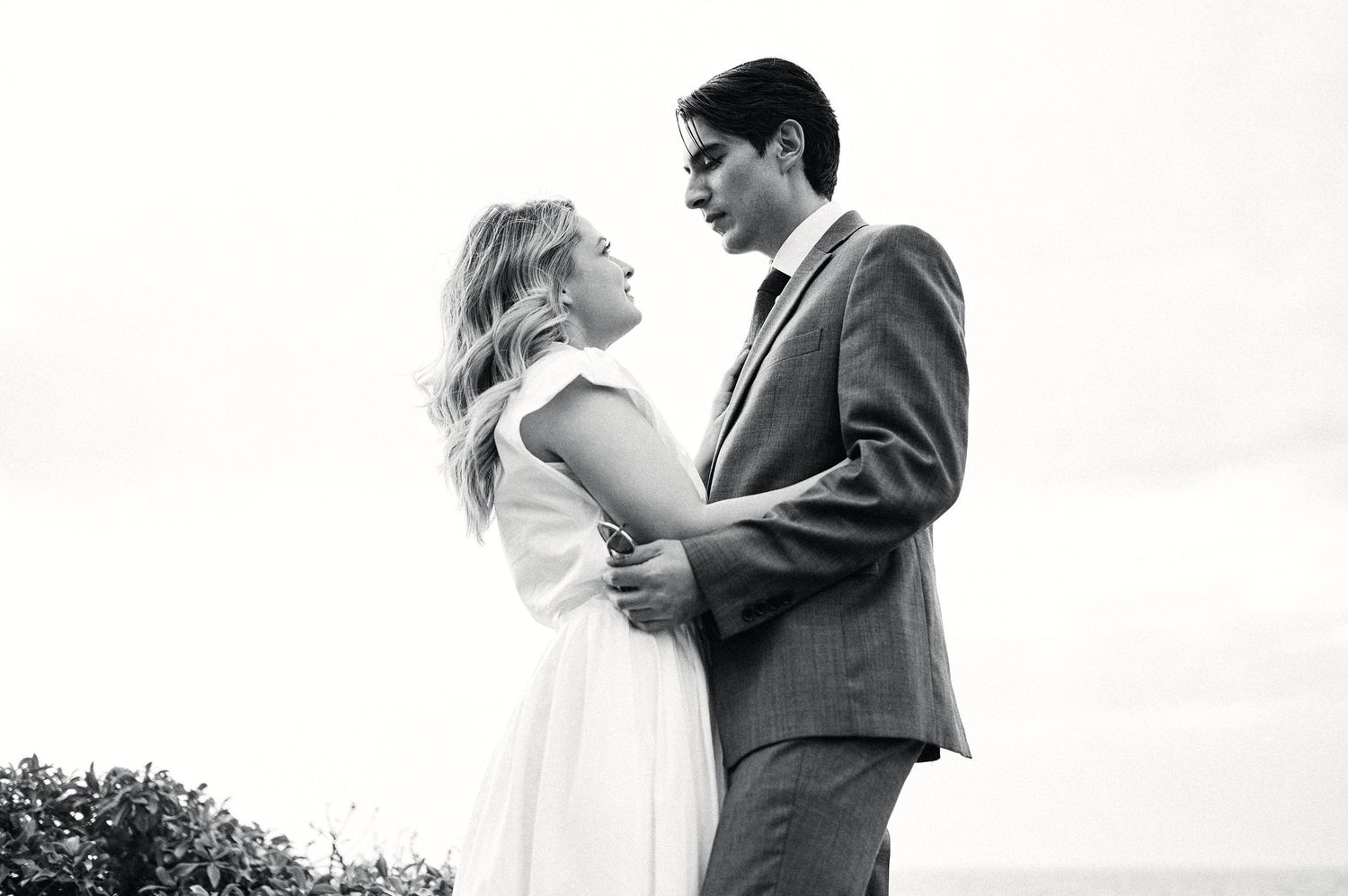 Series of romantic wedding portraits taken against a bright white background.