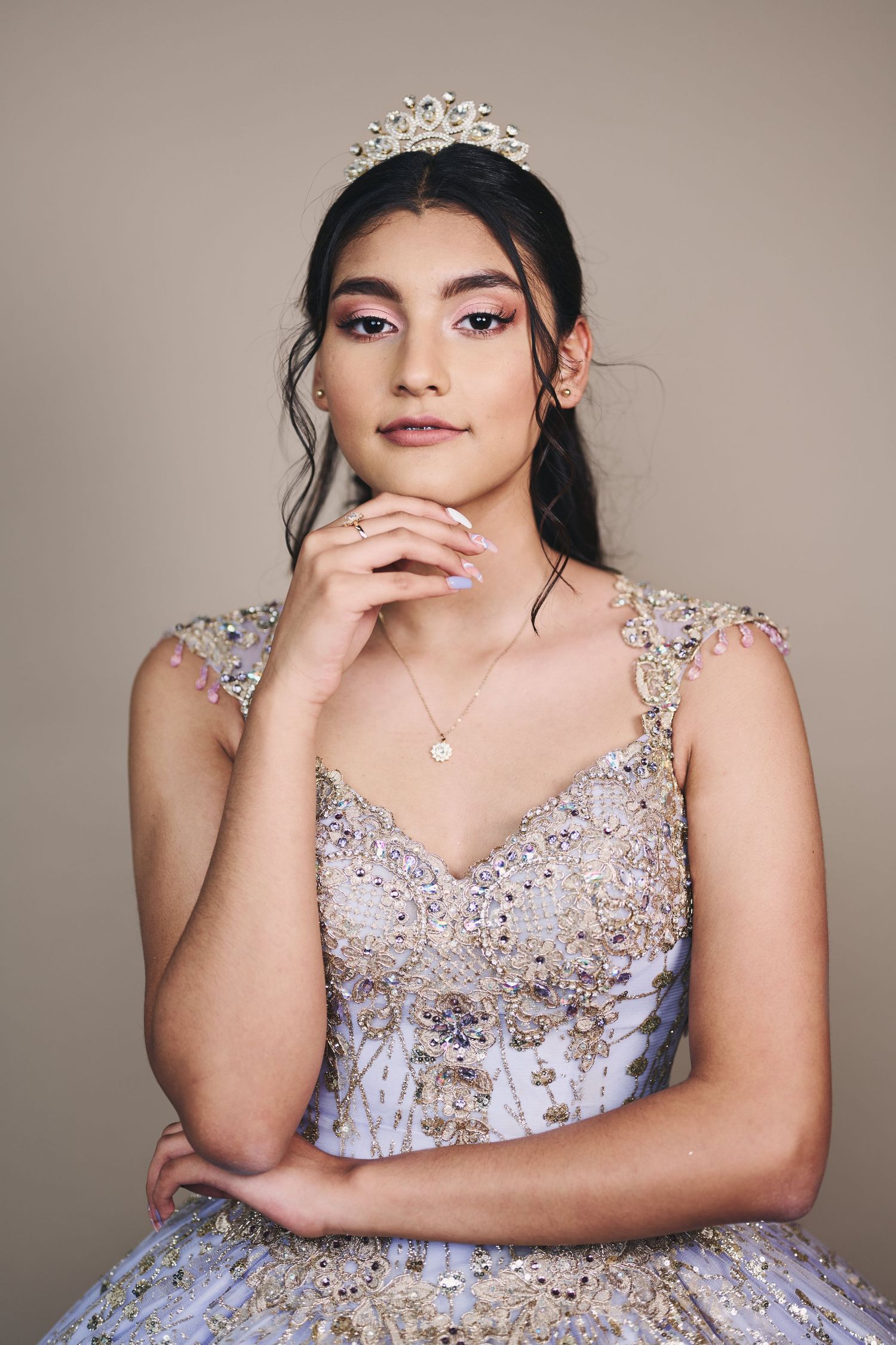 Formal portrait session featuring a sparkly lavender ballgown against neutral background.