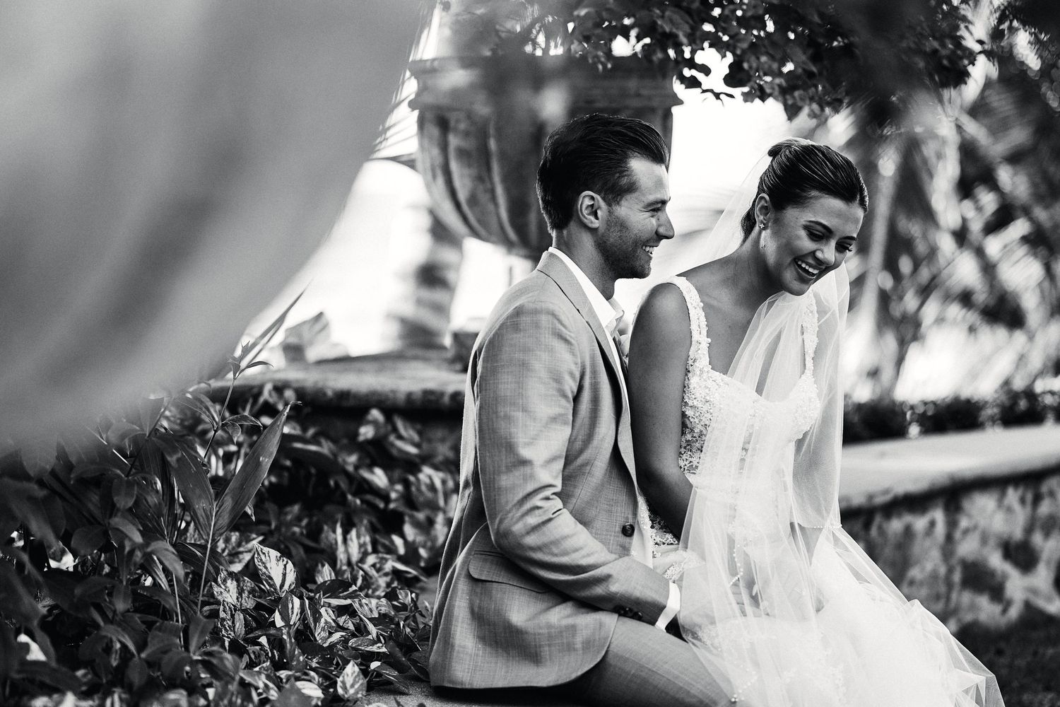 A romantic moment captured between newlyweds in a garden setting.