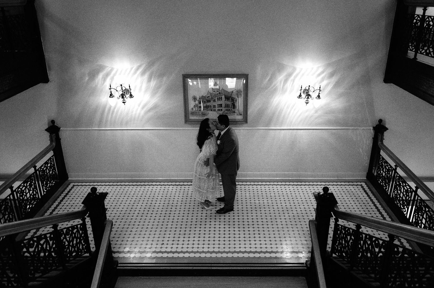 Artistic black and white overhead view of a grand staircase with dramatic lighting.