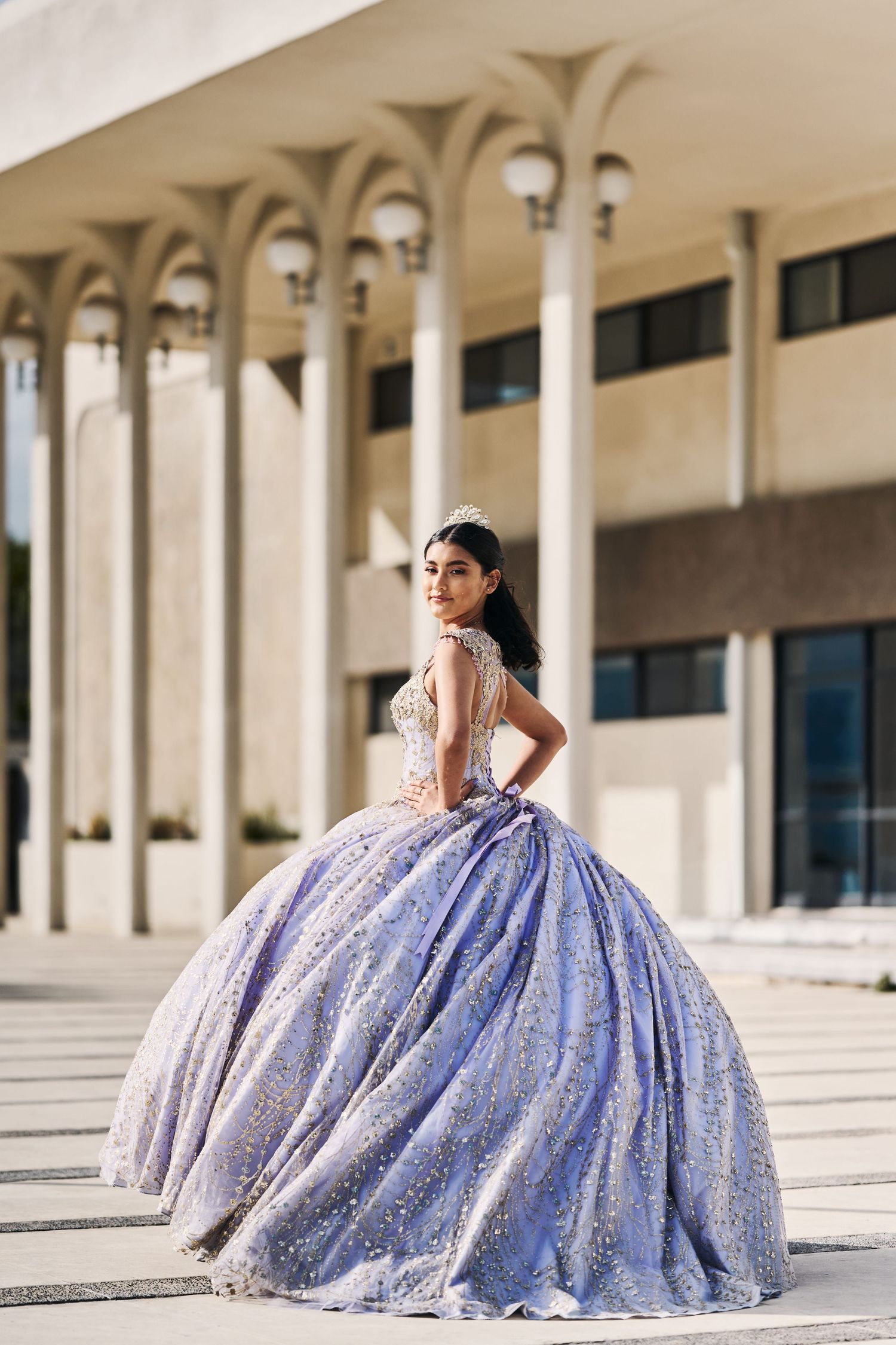 Lavender ballgown photographed in front of modern architectural columns.