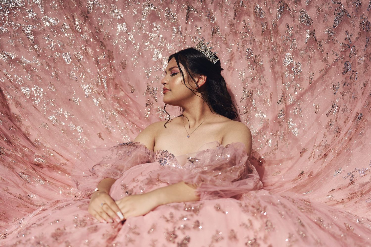 Detailed view of a blush pink princess gown with delicate embroidery and beading.