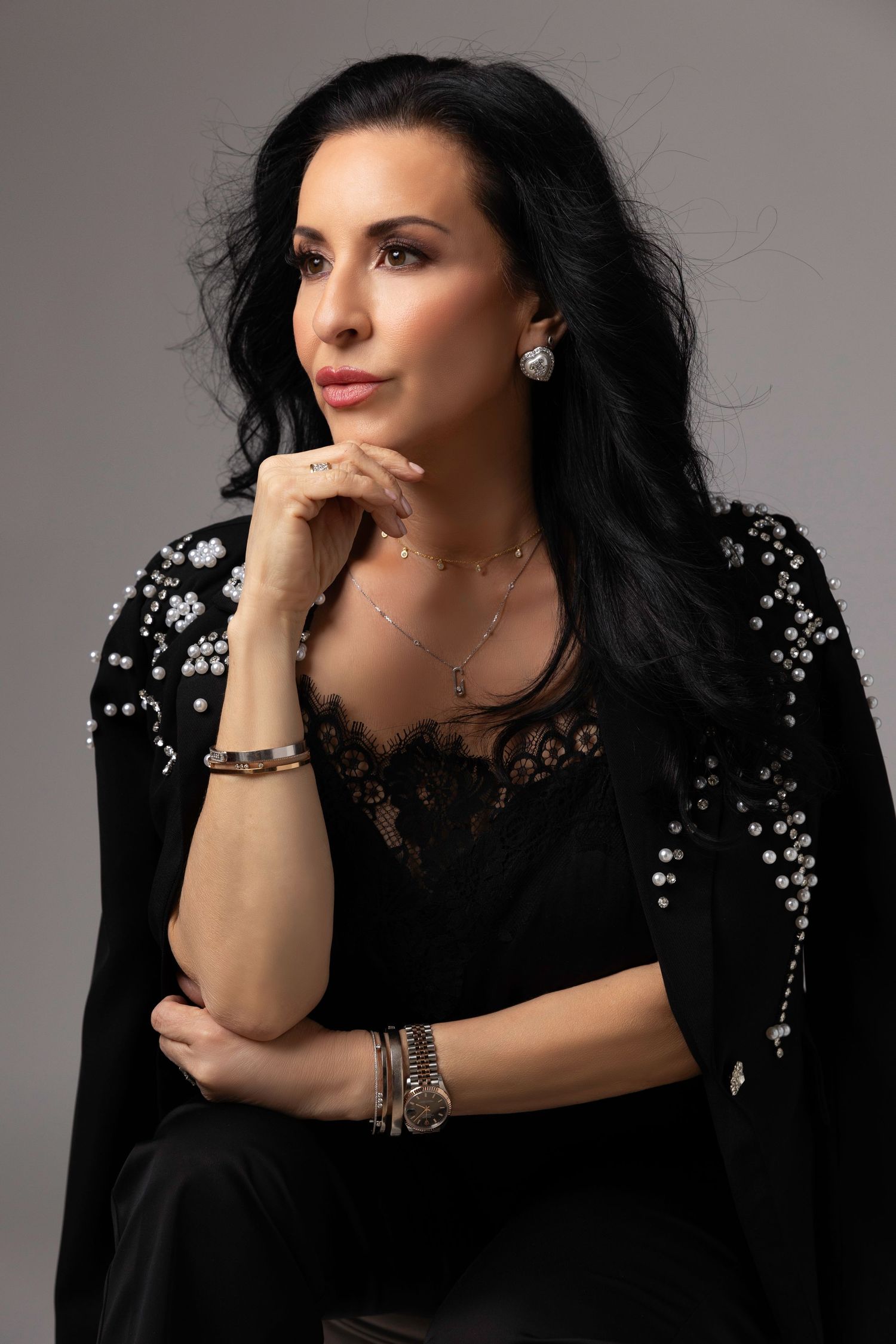 A series of glamour portraits featuring someone in a black sequined dress with dark hair against a gray studio backdrop.