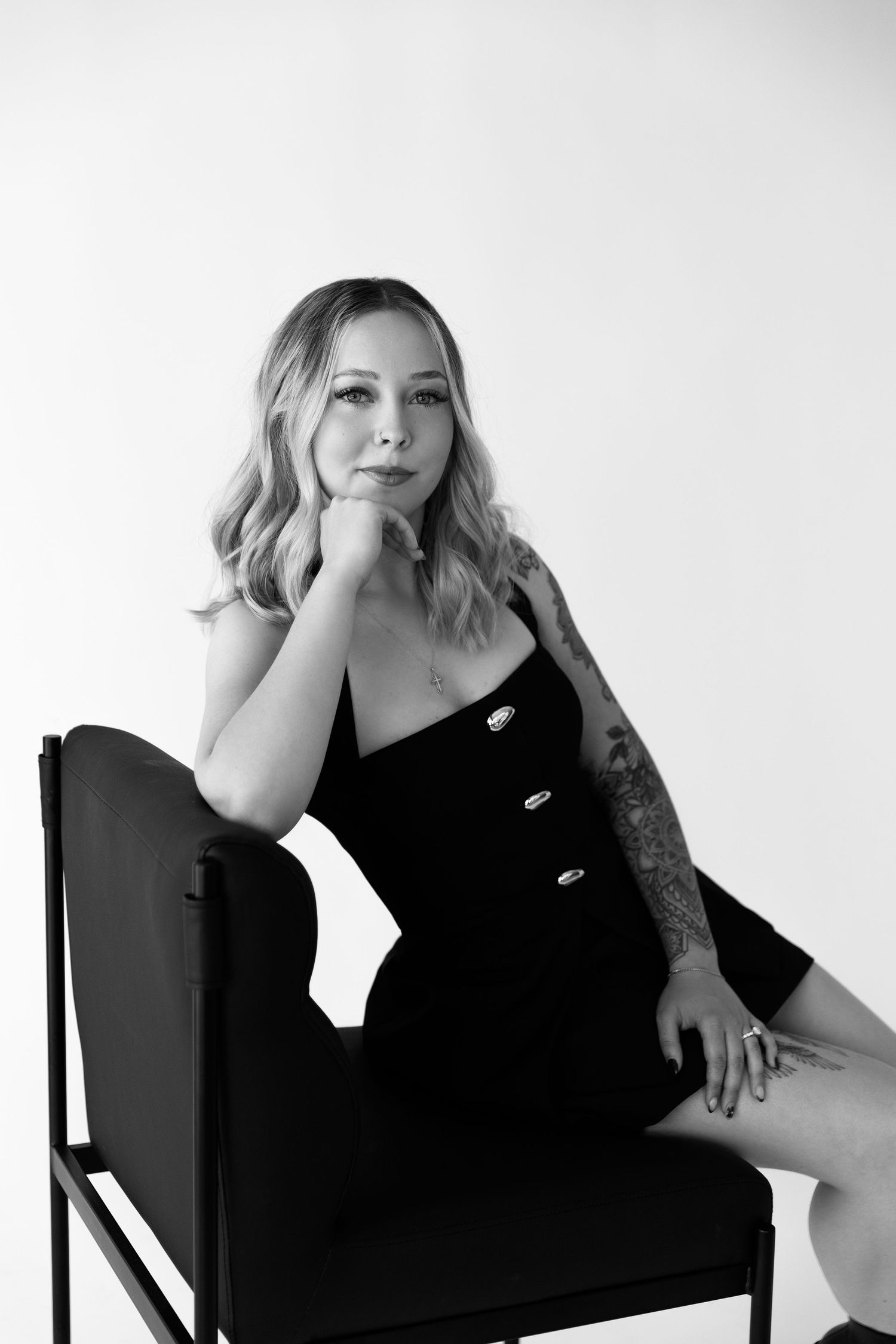 Black and white portrait series of woman in dark top posing on chair.  Photoshoot for business owner.Located in Palm Desert, California.