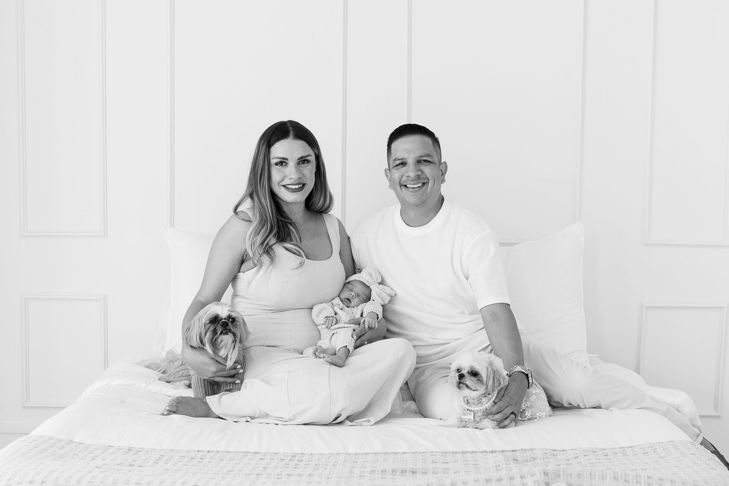 Family lifestyle photography on white bedding showing relaxed candid moments.  Located in Palm Desert, California.