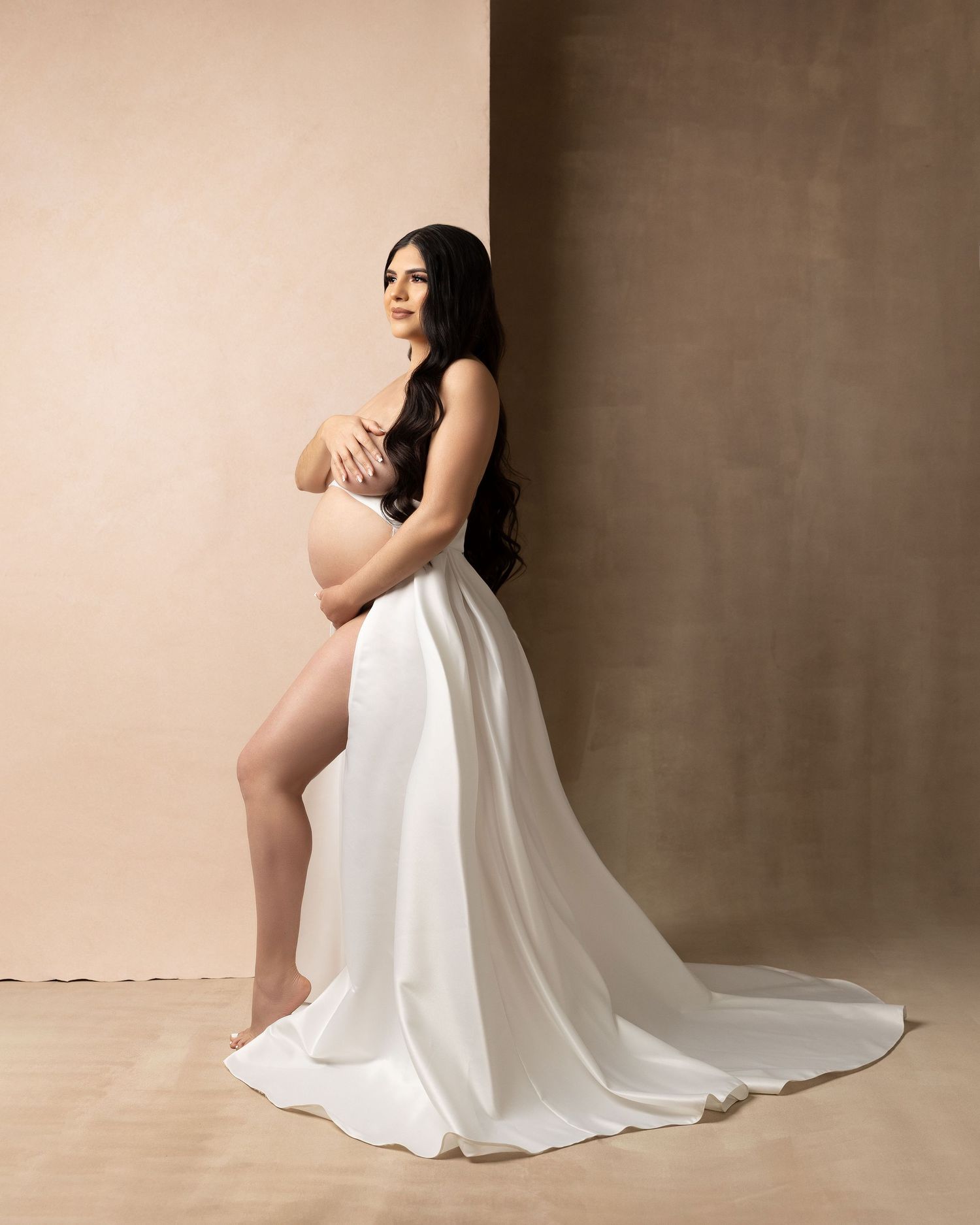 A series of artistic maternity portraits showing a woman in a flowing white dress against a neutral backdrop.