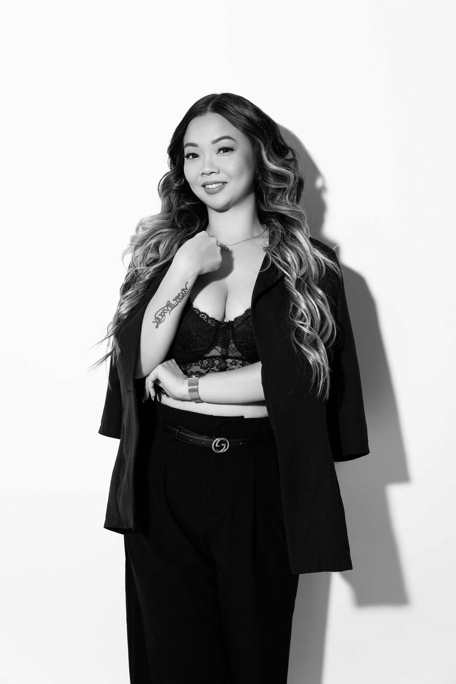 Black and white fashion portrait series showing model in casual black t-shirt against white background.