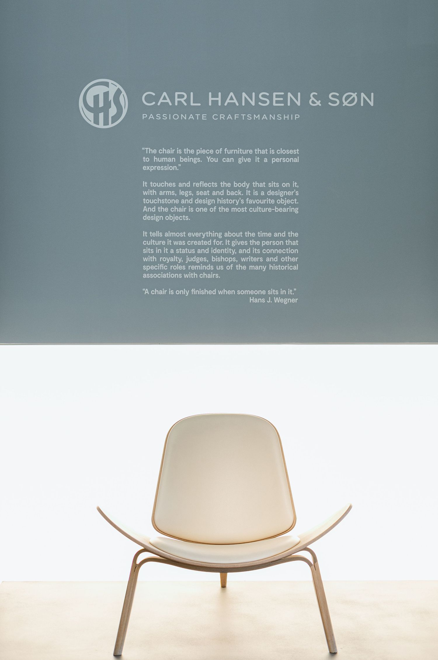 Three minimalist lounge chairs in cream color with curved wooden shells shown from different angles against white backdrop.