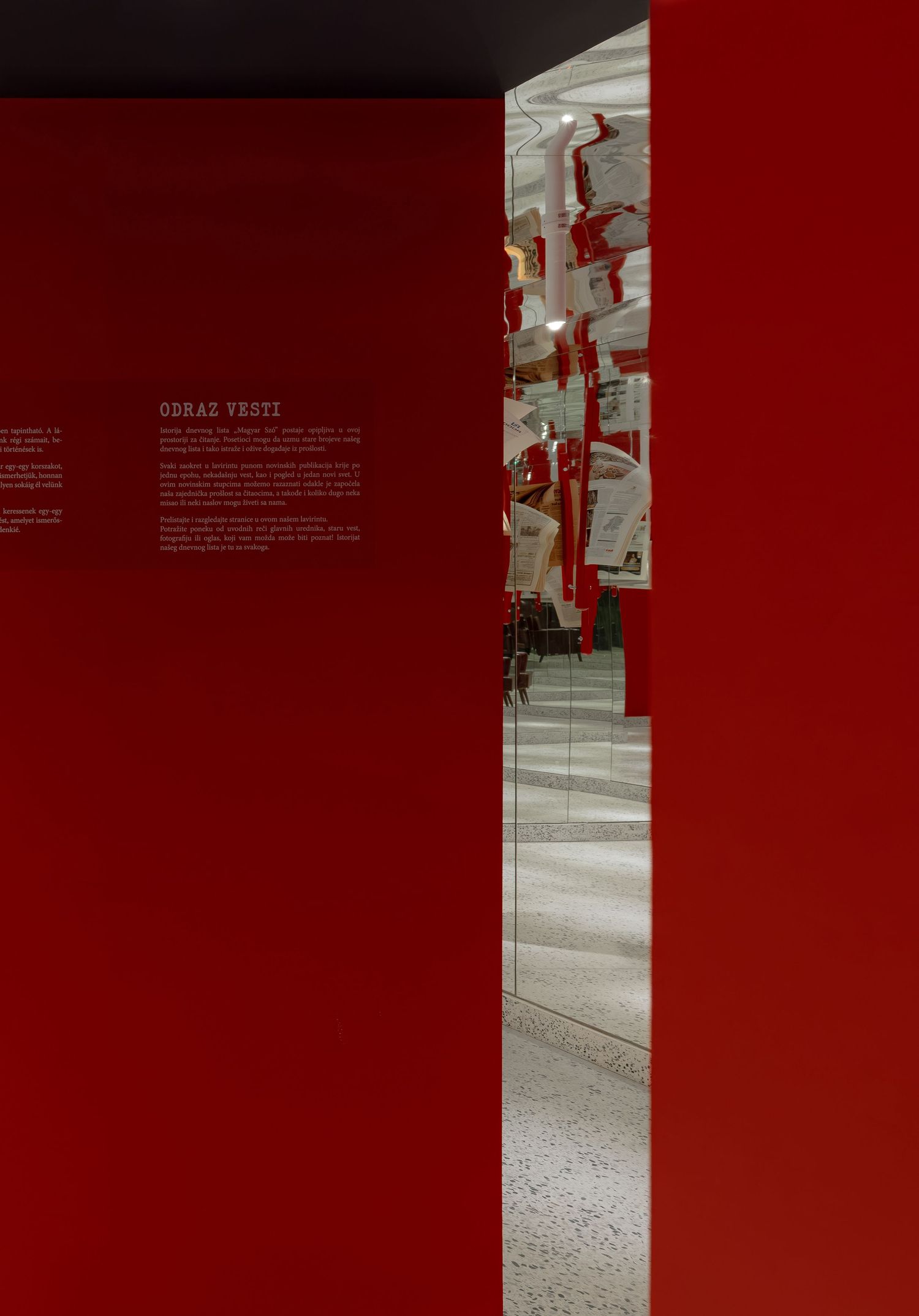 Abstract architectural composition with red panels and grey concrete stairs creating a modern geometric pattern.