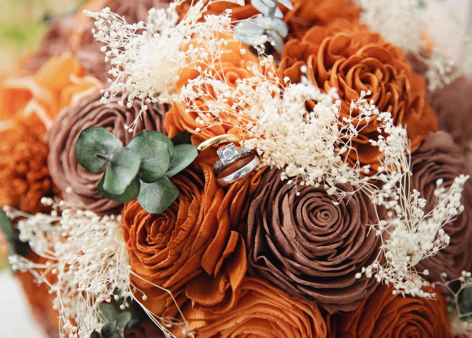 Close-up macro shots of brown roses with delicate white baby's breath flowers arranged in a romantic floral pattern.