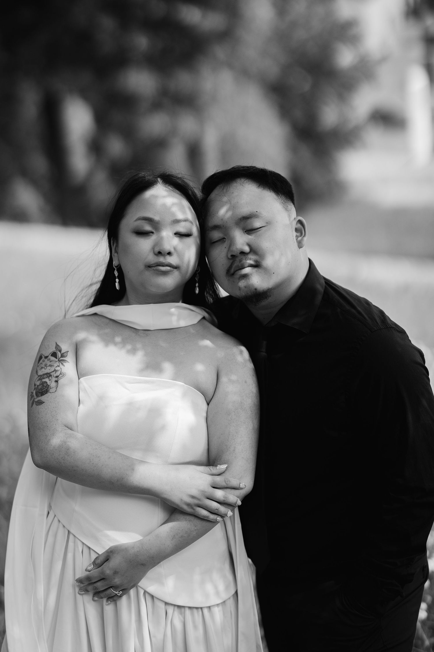 A romantic black and white photo series showing a couple embracing tenderly in matching outfits.