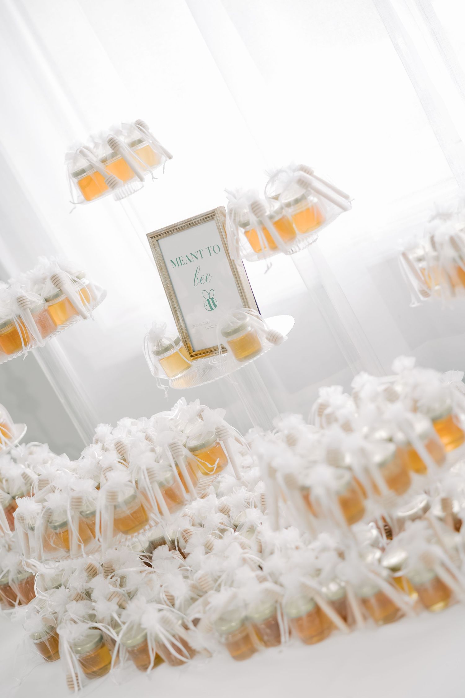Delicate white flowers and perfume bottles arranged in an elegant display with soft lighting.