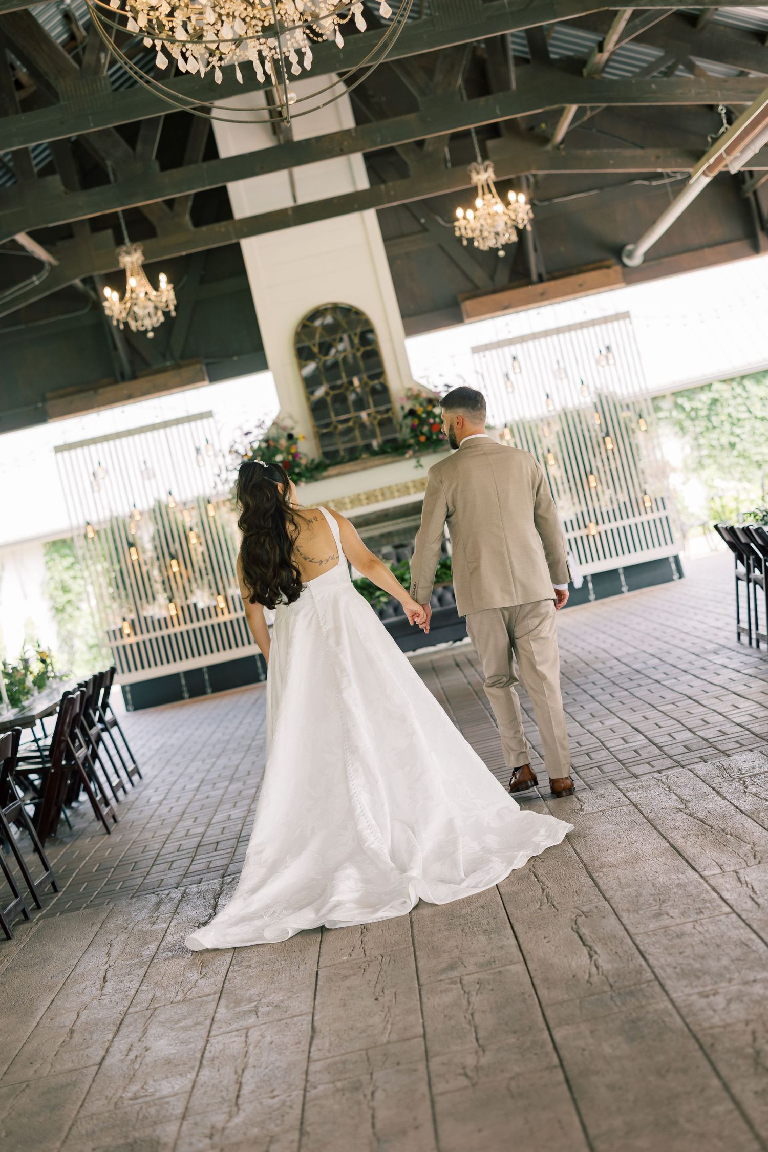 A sequence of wedding photos showing a couple dancing under an elegant chandelier in a rustic venue.