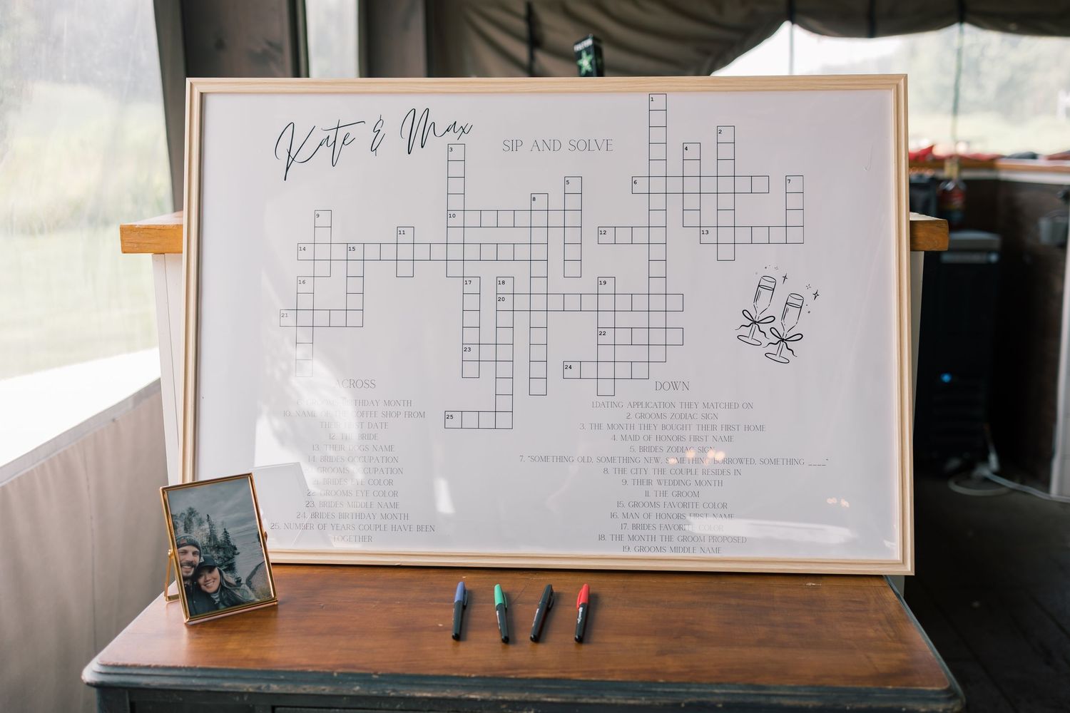 Crossword puzzle displayed on a wooden table at what appears to be a wedding reception.