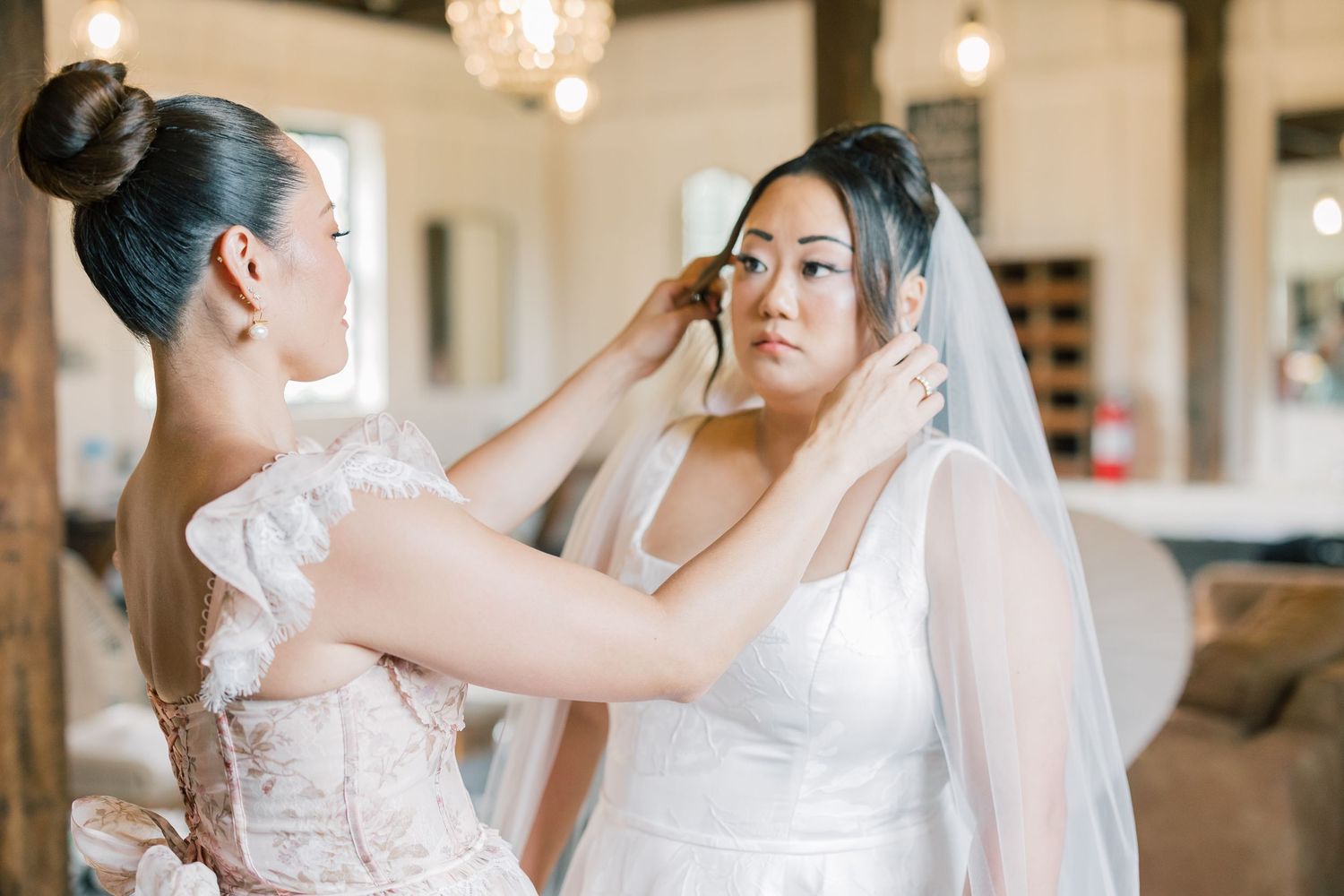 Wedding preparation scene in an elegantly lit indoor venue.