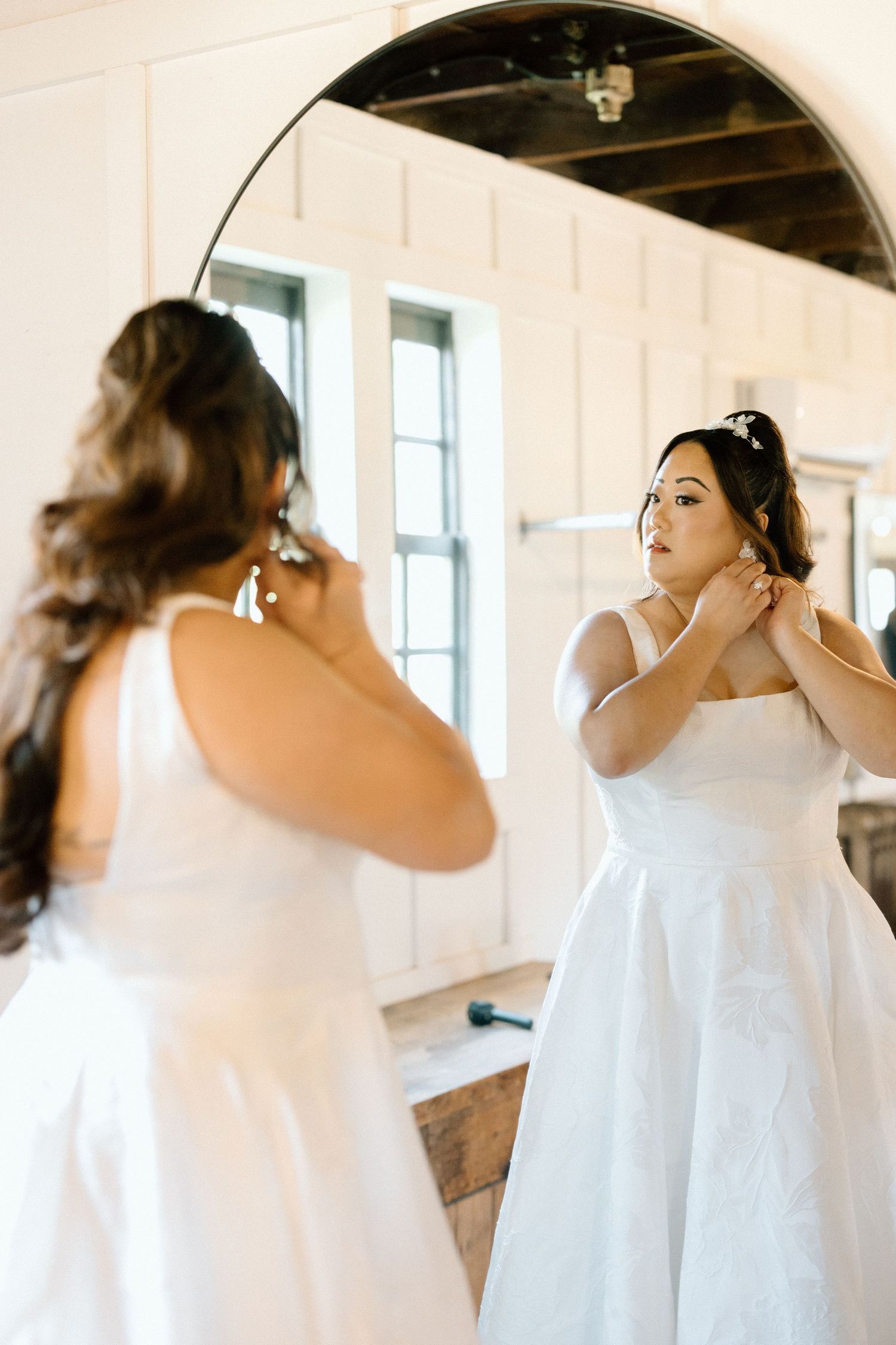 Sequence showing someone in a white dress getting ready in front of a mirror.