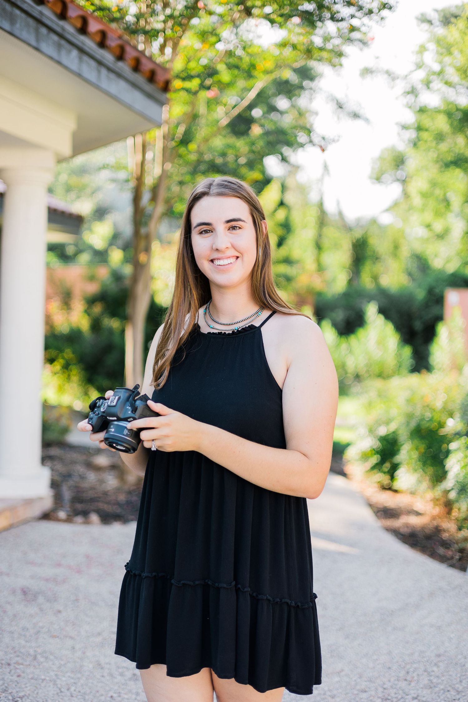 Autumn Elizabeth, a luxury wedding photographer, captured in action holding her camera with focus and precision. This im