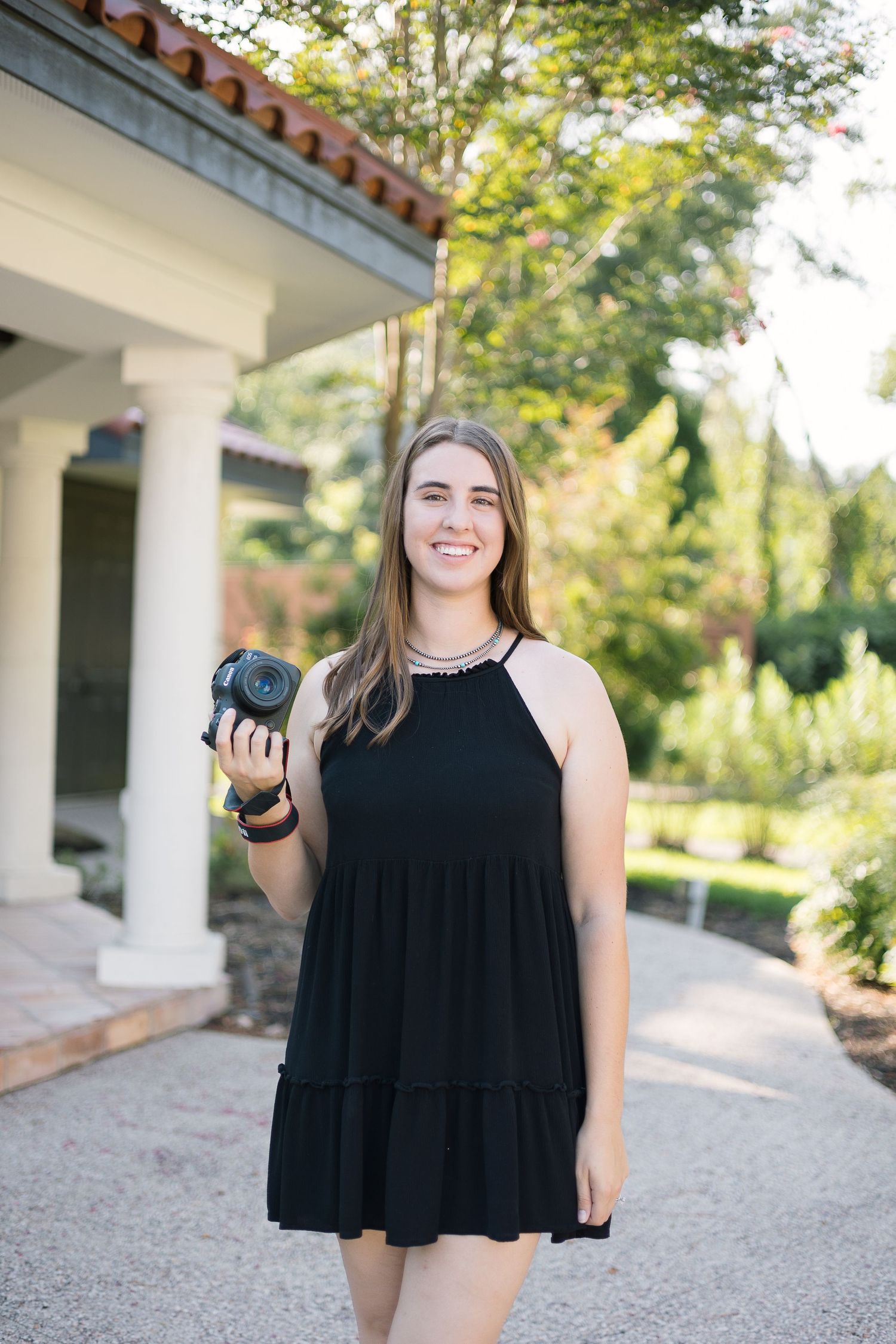 Autumn Elizabeth, a luxury wedding photographer, captured in action holding her camera with focus and precision. This im