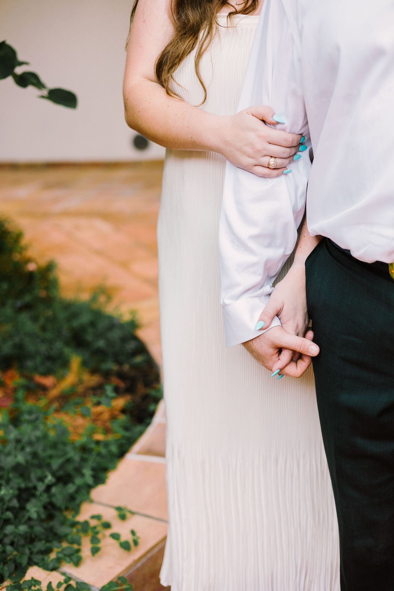A close-up photograph of hands gently holding each other, capturing the intimacy and connection between the individuals.