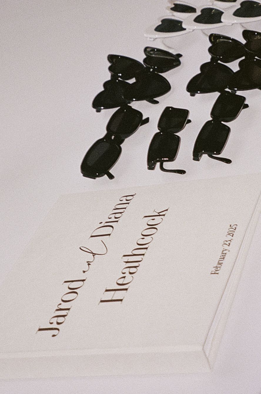 Wedding invitation design featuring silhouetted figures in black against white background. Film Photograph.