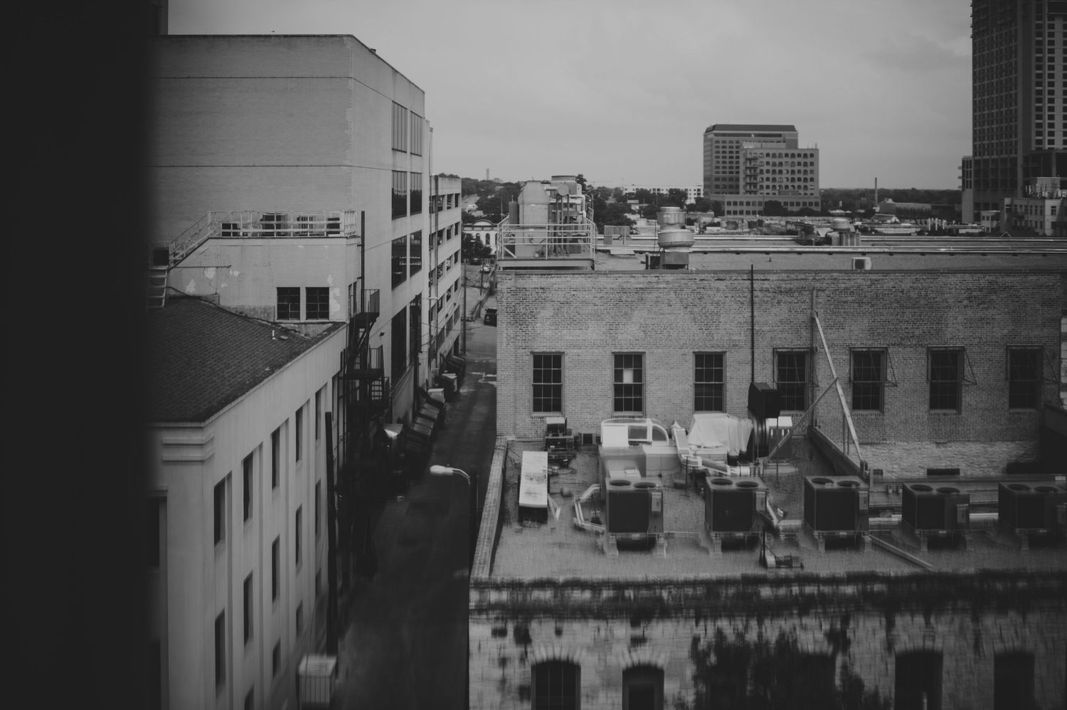 Black and white aerial view of urban city buildings and streets.