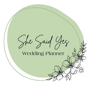 She Said Yes Wedding Planner logo with elegant script text on a green oval background with delicate floral illustrations.