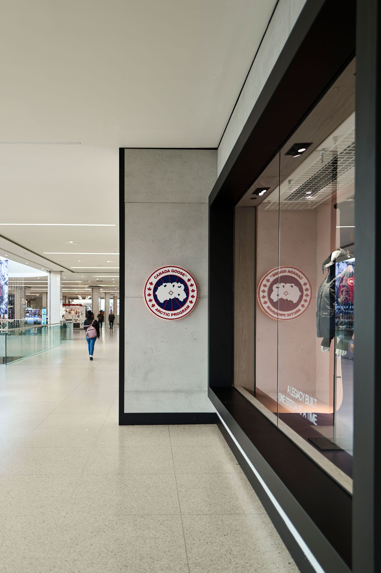 Commercial retail photography by Ayo Erinle — Canada Goose Edmonton store entrance with logo signage and display window.