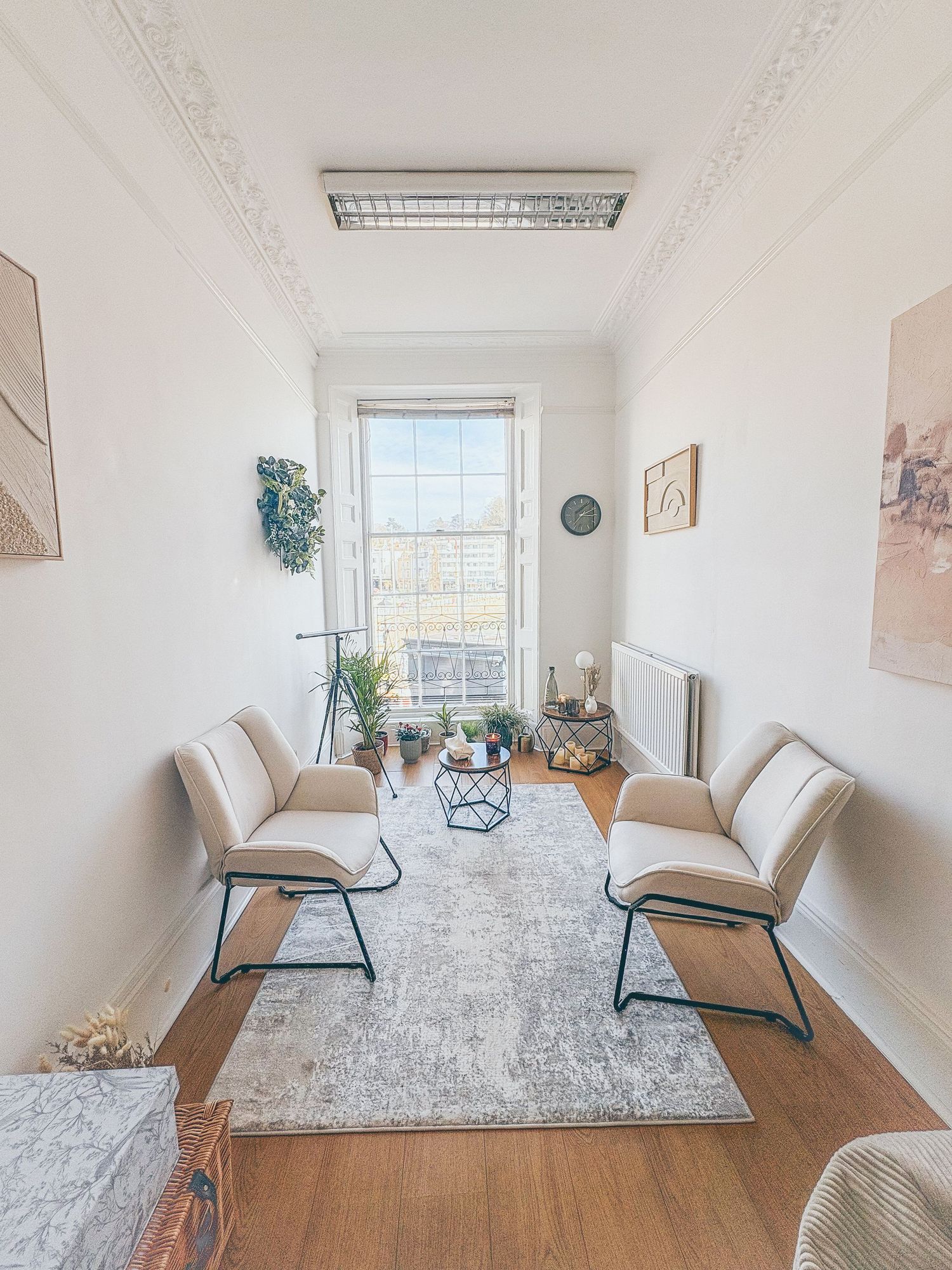 A calm, modern therapy room with soft neutral tones, comfortable seating, and a welcoming, private setting designed for counselling and EMDR