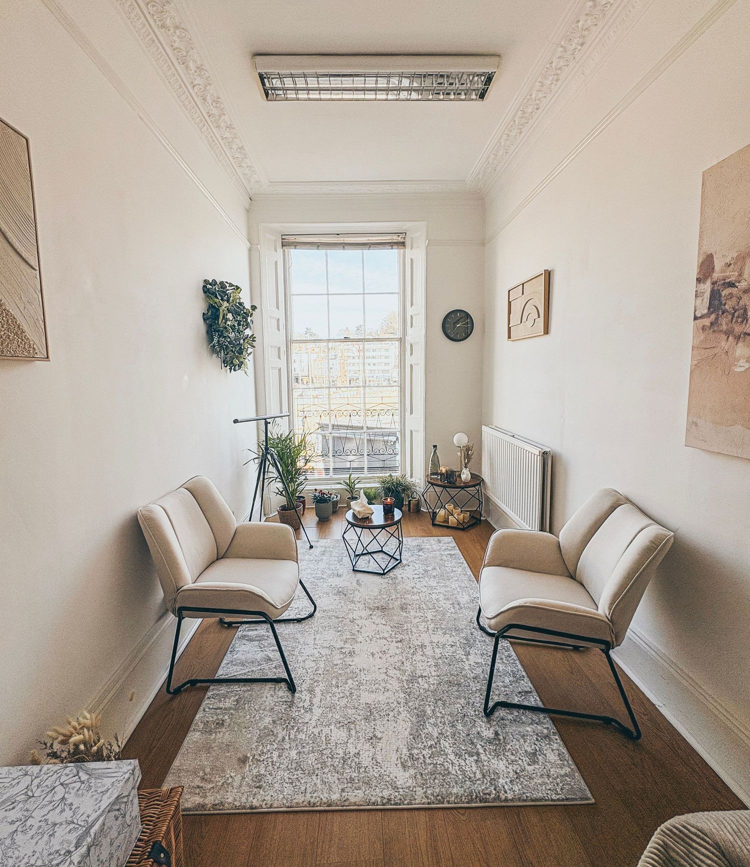 A calm, modern therapy room with soft neutral tones, comfortable seating, and a welcoming, private setting designed for counselling and EMDR