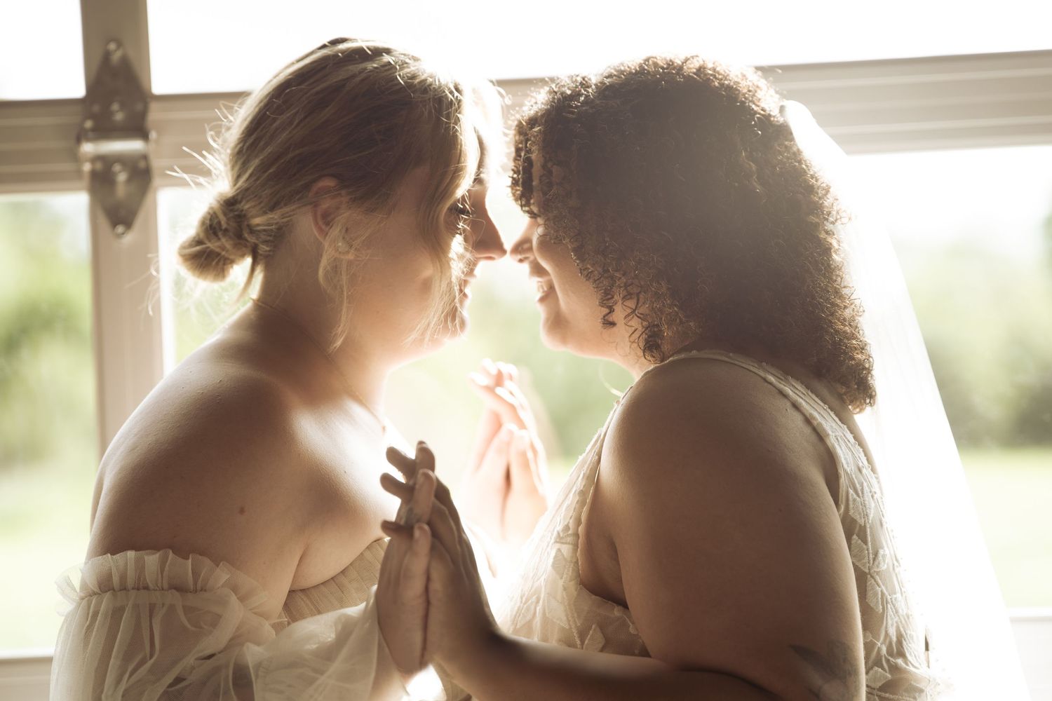 Two romantic figures sharing an intimate moment in soft natural window light.