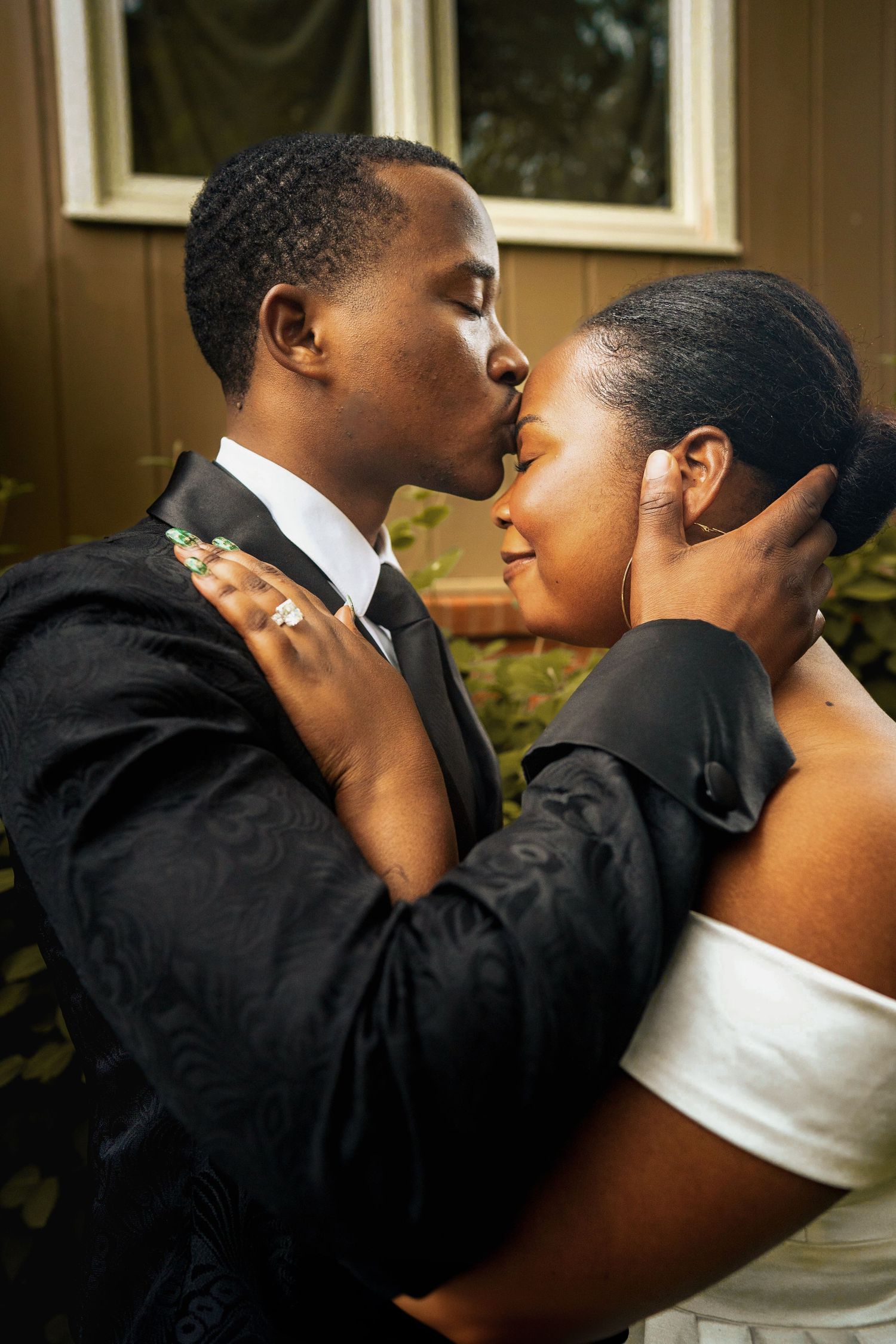 Tender wedding moment captured in soft natural lighting.