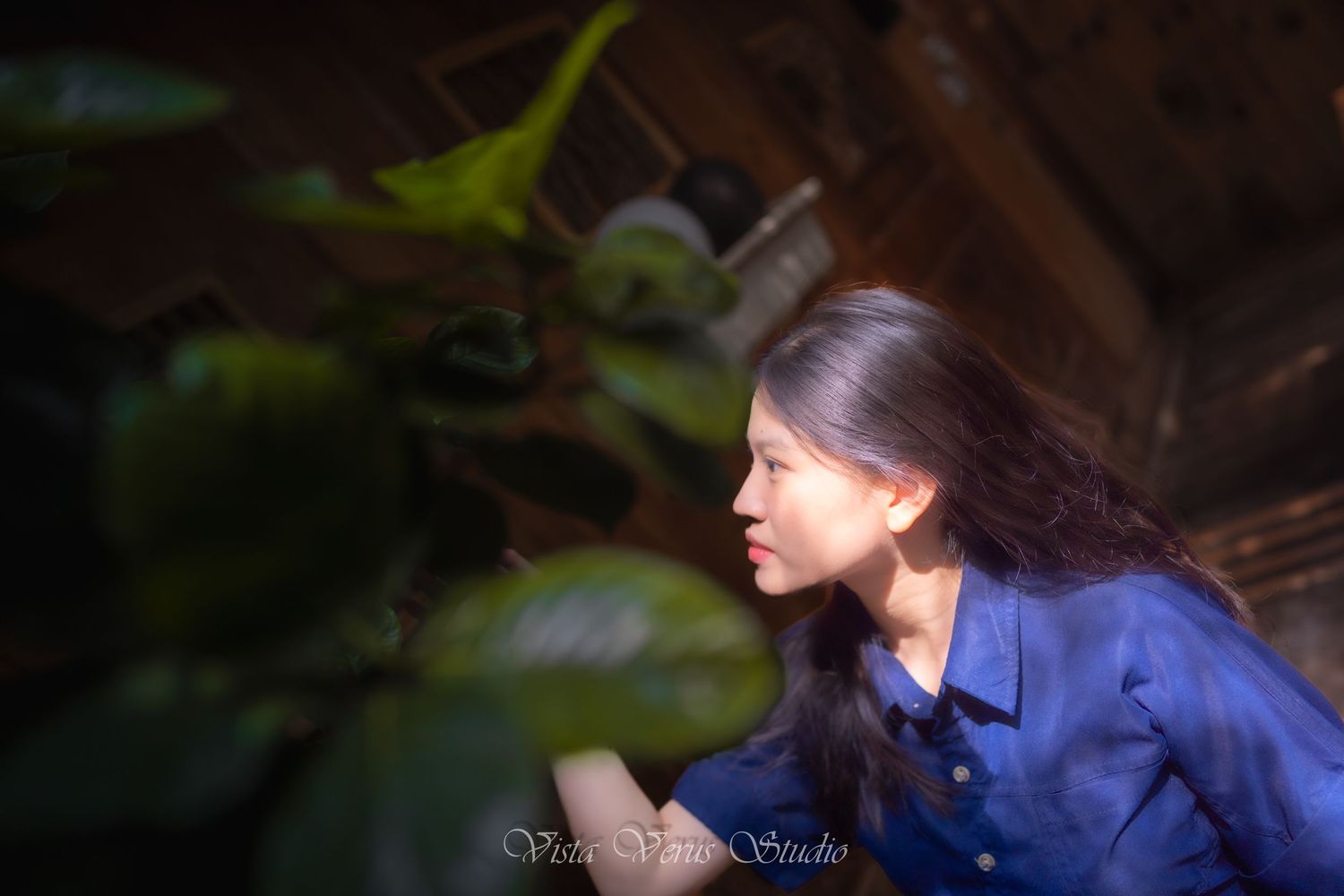 Side profile shot in natural lighting with soft focus and green foliage.
